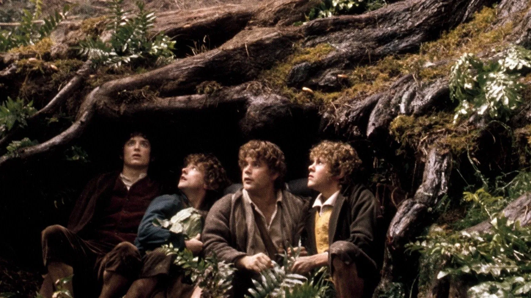 The fellowship traveling through mountains in The Lord of the Rings
